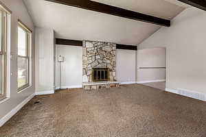 Unfurnished living room with a textured ceiling, a fireplace, and carpet flooring