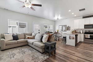 Living room featuring dark wood finished floors, recessed lighting, and a ceiling fan