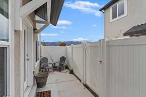 Fenced backyard with a patio area, a mountain view, and a gate