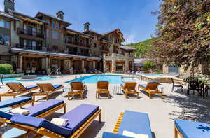 Community pool with a jacuzzi and a patio