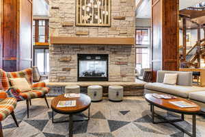 Living area with a fireplace and stairs
