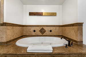 Primary Bathroom featuring a jetted tub