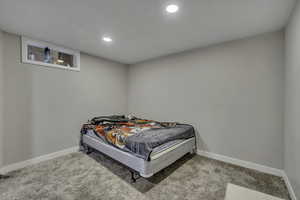 Bedroom featuring light colored carpet and recessed lighting