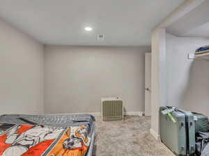Carpeted bedroom with baseboards and recessed lighting
