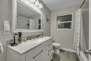 Bathroom featuring vanity, light wood-style flooring, and shower / bath combo