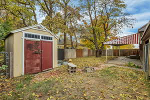 View of shed with a fenced backyard