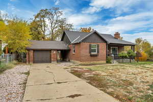 Ranch-style home with brick siding, a shingled roof, concrete driveway, and a garage