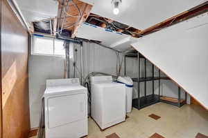Laundry area featuring light flooring and independent washer and dryer