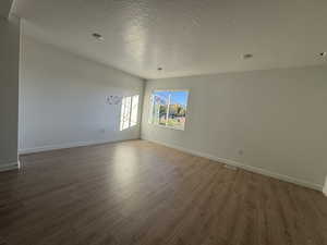 Spare room with light wood-style flooring and a textured ceiling