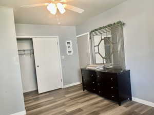 Bedroom featuring wood finished floors, ceiling fan, and a closet