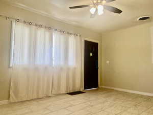 Spare room with baseboards and ceiling fan