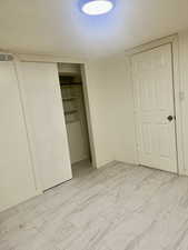 Unfurnished bedroom featuring a closet and light marble finish floors