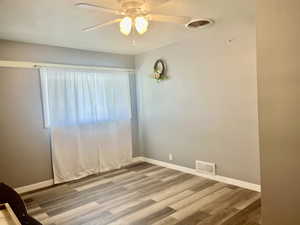 Unfurnished room featuring light wood finished floors and a ceiling fan