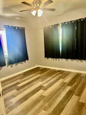 Empty room featuring wood finished floors and ceiling fan