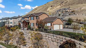 View of front facade featuring driveway, stucco siding, a garage, and a mountain view