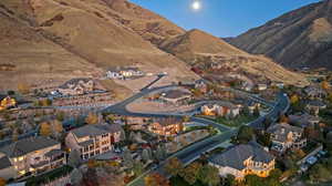 Aerial view of property's location with nearby suburban area and a mountainous background