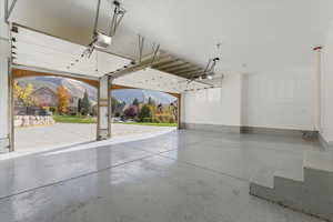 Garage featuring a mountain view and a garage door opener