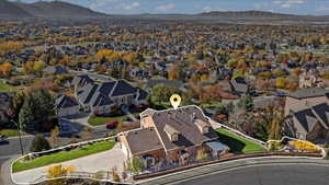 Aerial perspective of suburban area with a mountainous background and property boundaries highlighted