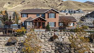 View of front of property with stucco siding, a fenced front yard, and a mountain view