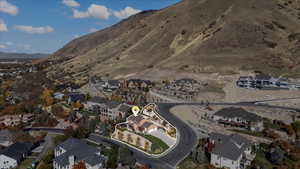 Aerial overview of property's location featuring nearby suburban area and mountains