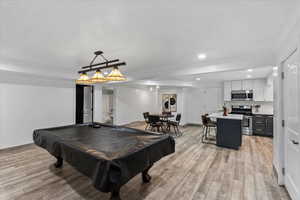 Rec room with billiards, light wood-style floors, and recessed lighting