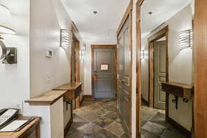 Hallway with stone tile floors