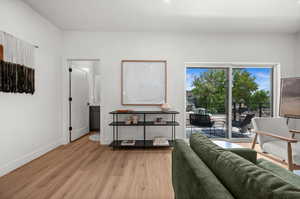 Living area featuring light wood-type flooring and baseboards