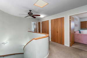 Upstairs landing area looking into 2 of the 3 bedrooms, plus storage closets.