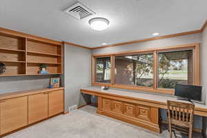 Office space featuring built in desks and overlooking the golf course