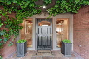 Doorway to property with brick siding