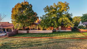 Back of house with a fenced backyard and lot line.