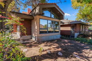 View of back of property with brick siding