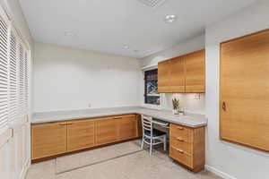 Laundry room with a foldout ironing board and extra workspace.