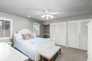 Bedroom on main level with multiple closets, carpet floors, a ceiling fan, and recessed lighting