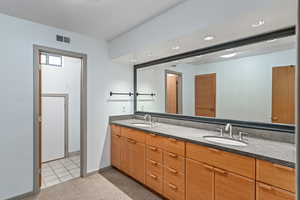 Full bathroom with double vanity, light tile patterned floors, light carpet, and recessed lighting