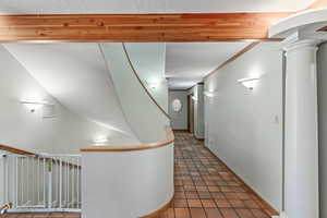 Hallway off entry that leads to Primary suite, a guest bedroom, laundry room, powder bath, and garage