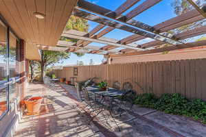 Fenced sideyard featuring outdoor dining area, a patio area, and a pergola