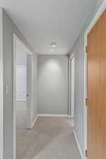 Downstairs hallway with bedroom and full bathroom.