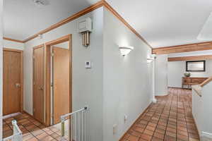 Hallway looking back towards entry. On the left is the laundry room and entrance to Primary Suite.
