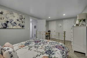 Bedroom featuring light carpet and recessed lighting