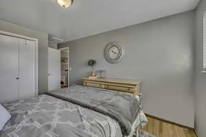 Bedroom with a closet and wood finished floors