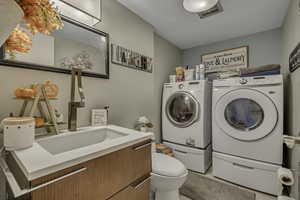 Bathroom featuring vanity and washer and dryer