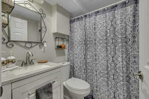 Full bathroom with vanity and curtained shower