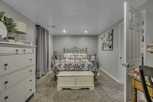 Bedroom featuring light colored carpet and recessed lighting