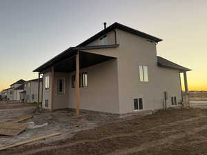 Property exterior at dusk with a patio area