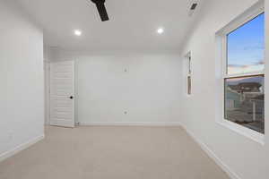 Spare room with light colored carpet, a ceiling fan, and recessed lighting