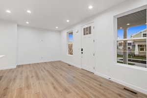 Entrance foyer with recessed lighting, light wood-style floors, and healthy amount of natural light