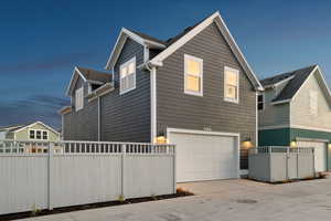 View of side of home featuring a garage and driveway