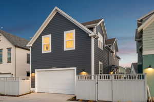 View of front facade with a garage and concrete driveway