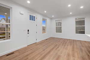 Entrance foyer with recessed lighting and light wood-style floors